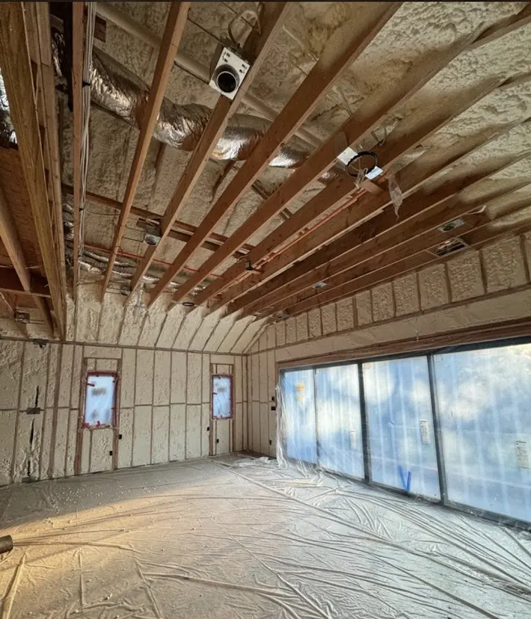 Interior walls and ceiling insulated with spray foam during new construction in New Baltimore